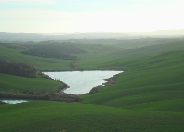 Terre di Siena, April. Morning light on two lakes between Leonina and Vescona, Crete Senesi, Asciano

